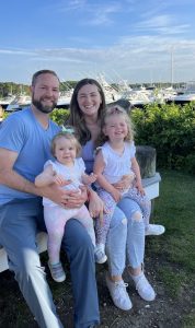 A picture of Jerry Bulman sitting with his wife and young daughters