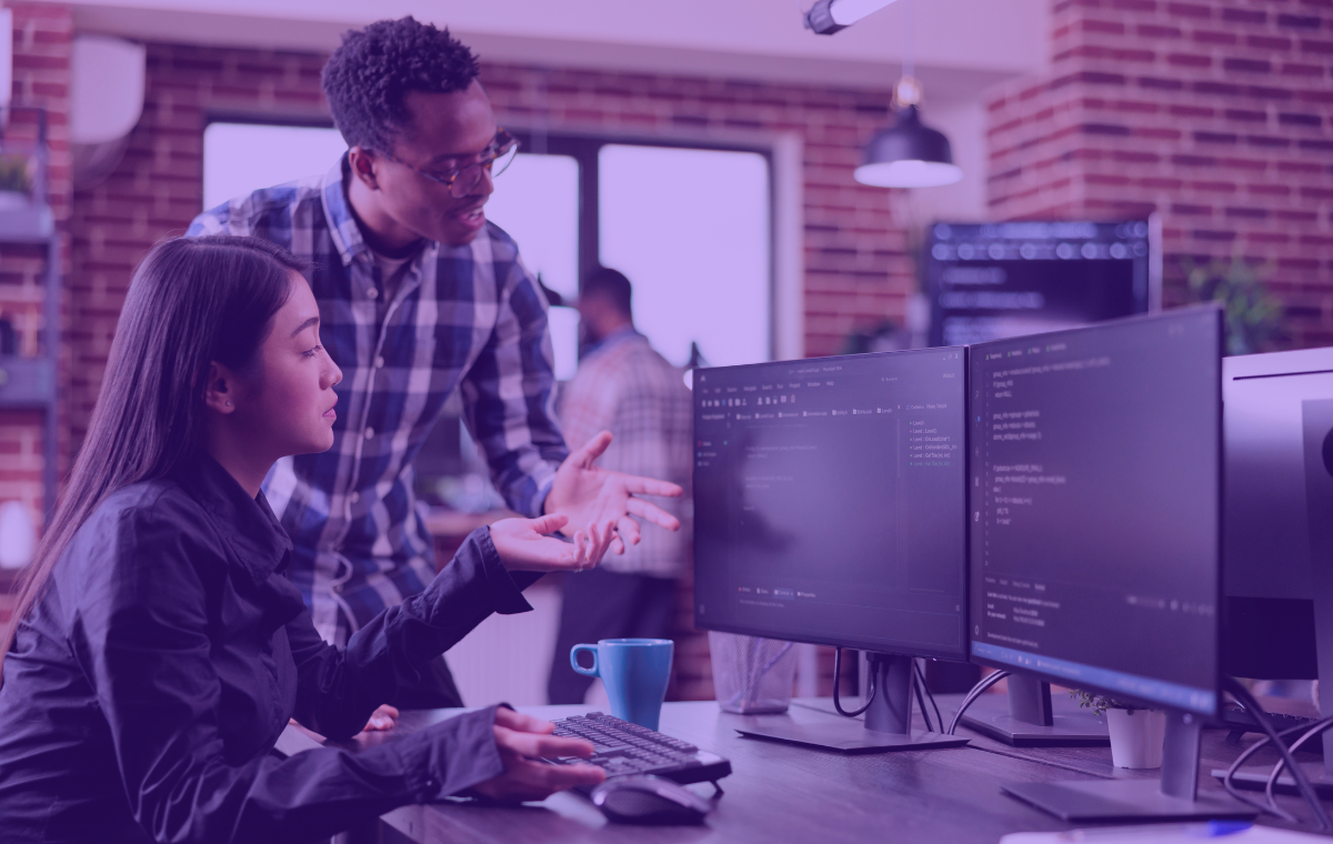 Two workers working on a computer for cybersecurity awareness month