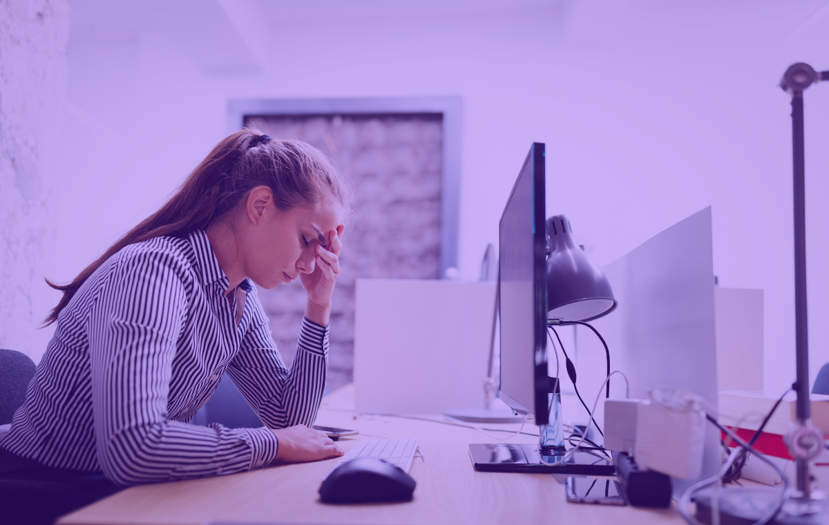 Worker frustrated looking at their desktop computer