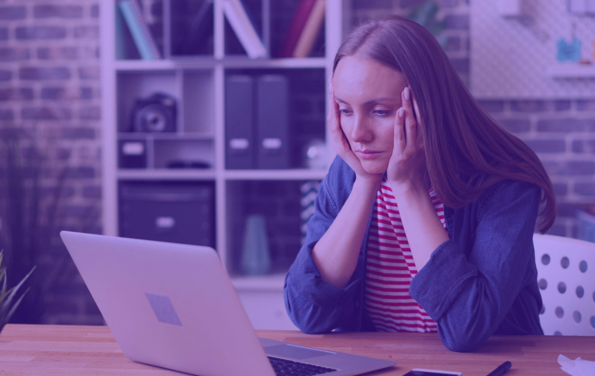 A woman frustrated by a slow website on a laptop